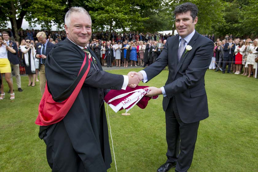 Commemoration Day 2014 - Outgoing Headmaster, Chris Edwards handing the flag to Mr Clague